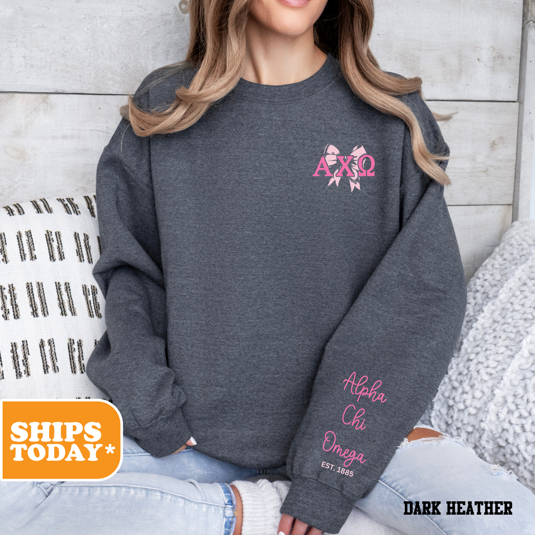 a woman sitting on a bed wearing a gray sweatshirt