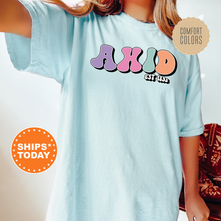 a woman wearing a blue shirt with the word ajaxd on it