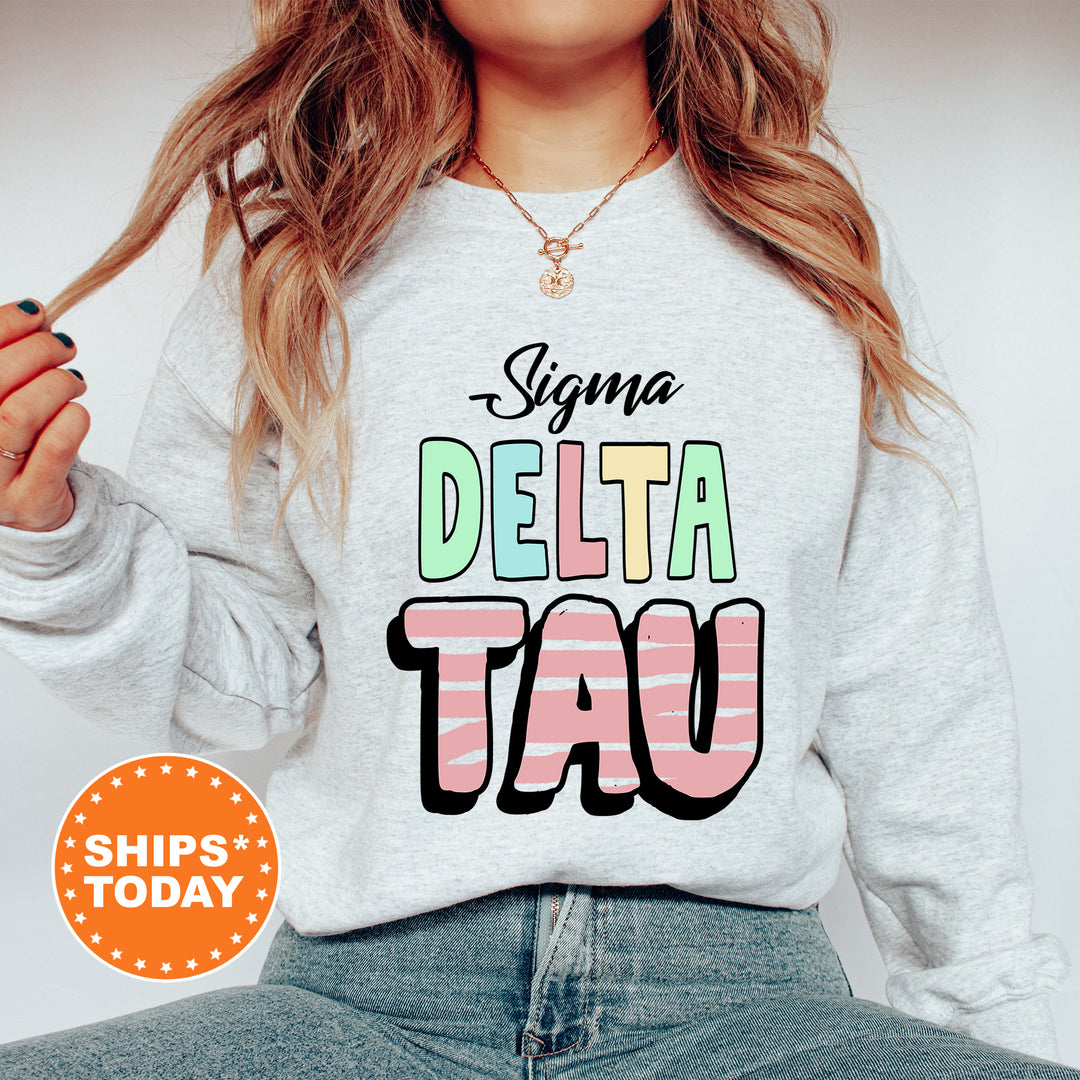 a woman wearing a sweatshirt that says delta tau