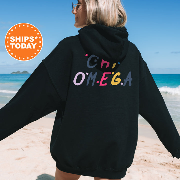 a woman wearing a black hoodie with the word omega printed on it