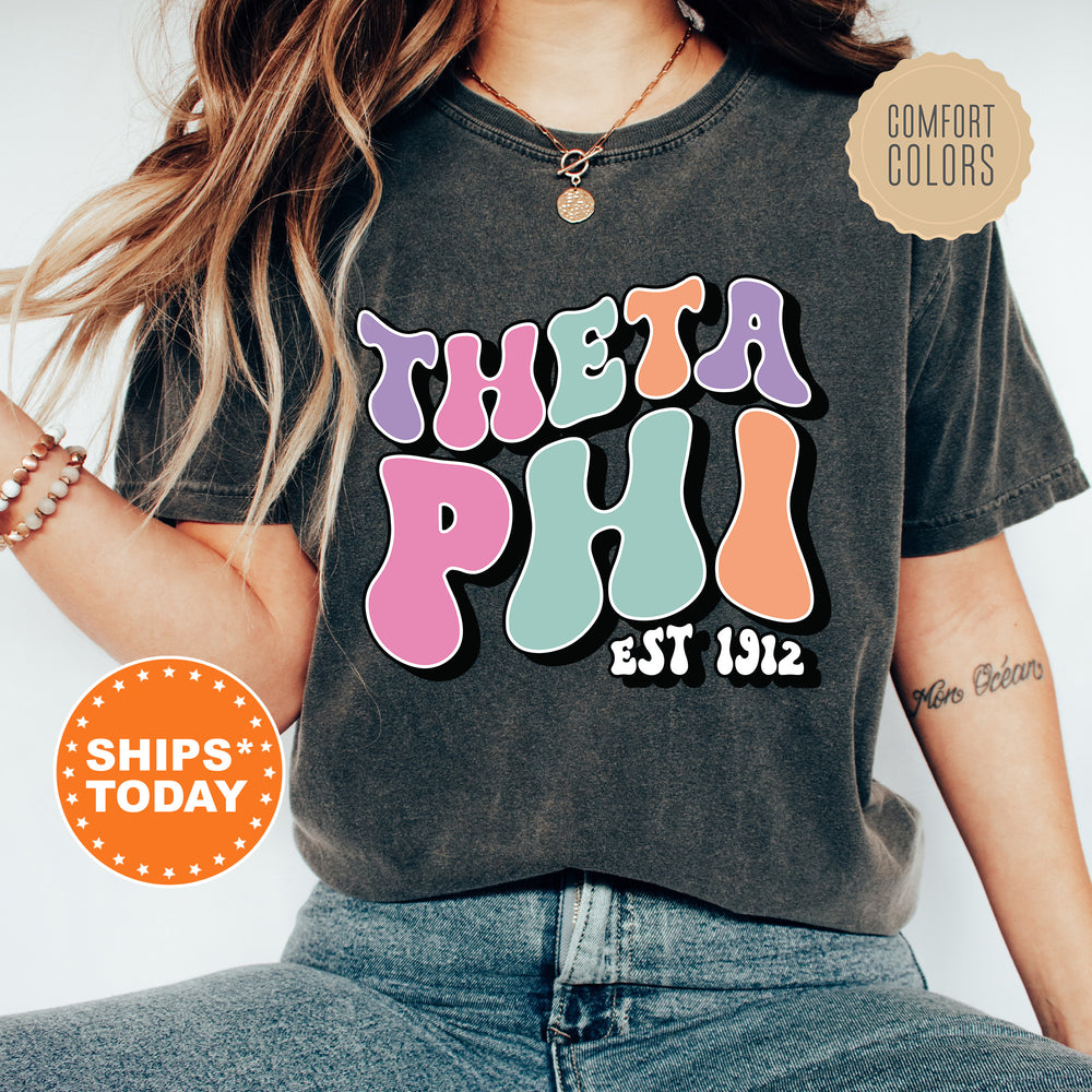 a woman wearing a t - shirt that says thea phi