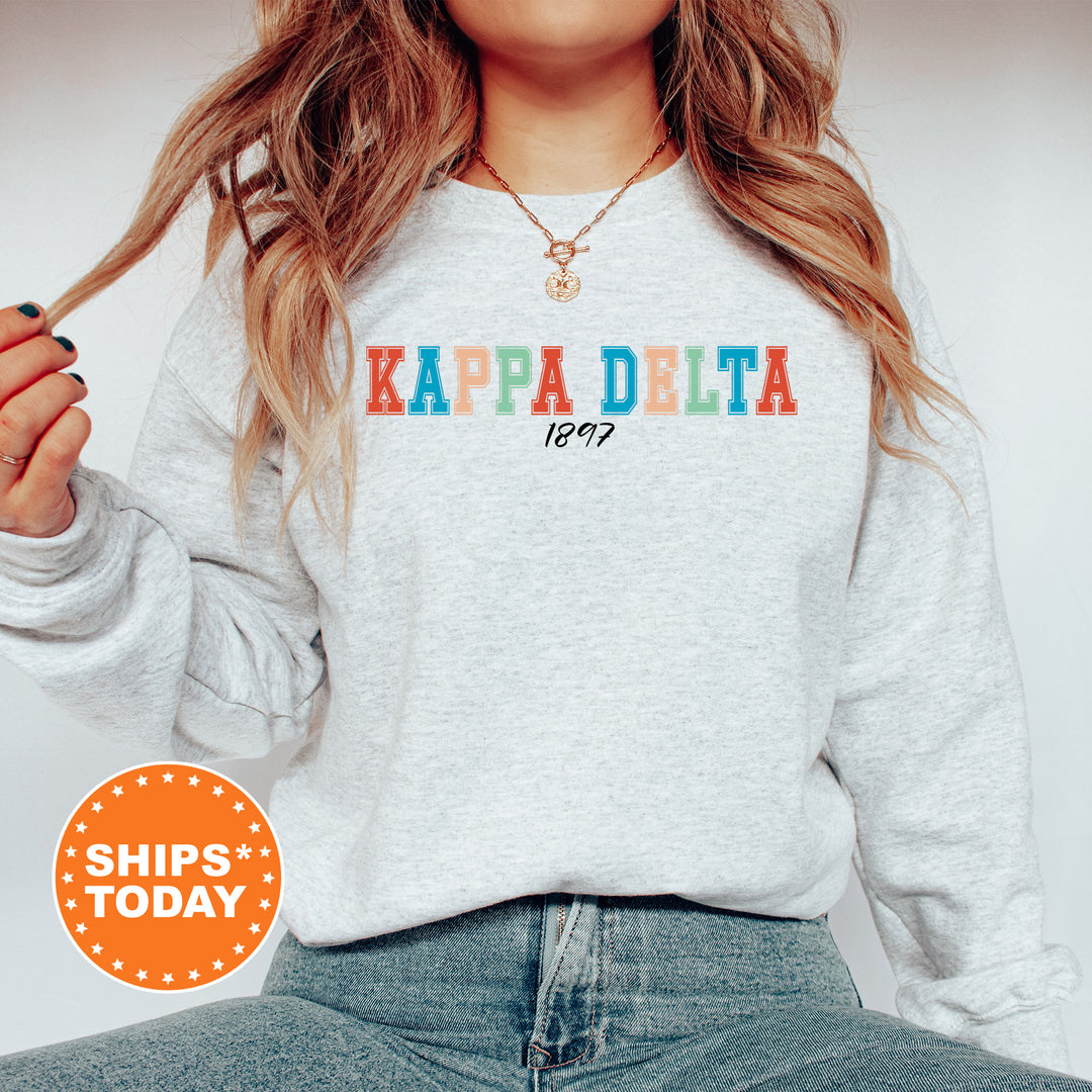 a woman wearing a sweatshirt that says kapa delta