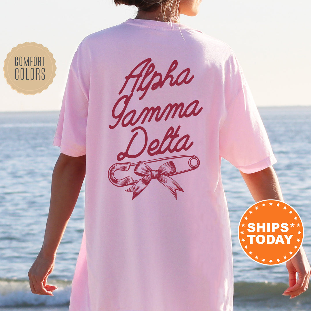 a woman standing on a beach wearing a pink shirt