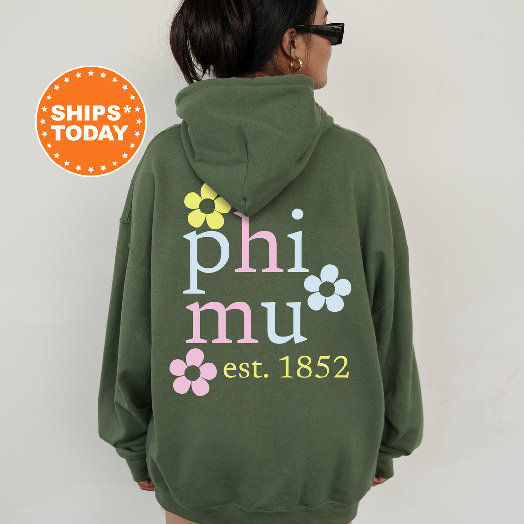 a woman wearing a green phi mu hoodie