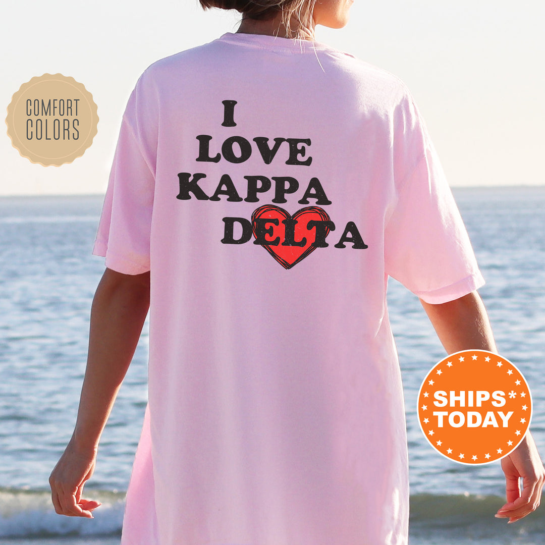 a woman wearing a pink shirt that says i love kapa delta