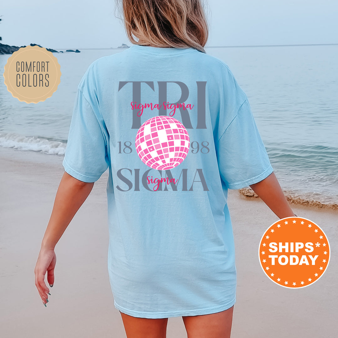 a woman walking on the beach wearing a t - shirt