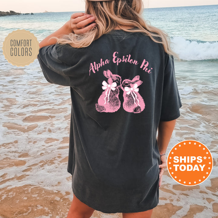 a woman standing on a beach wearing a black shirt