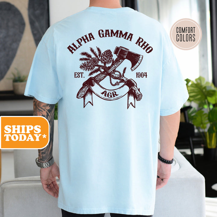 a man wearing a blue shirt with an image of a hammer and a pineapple