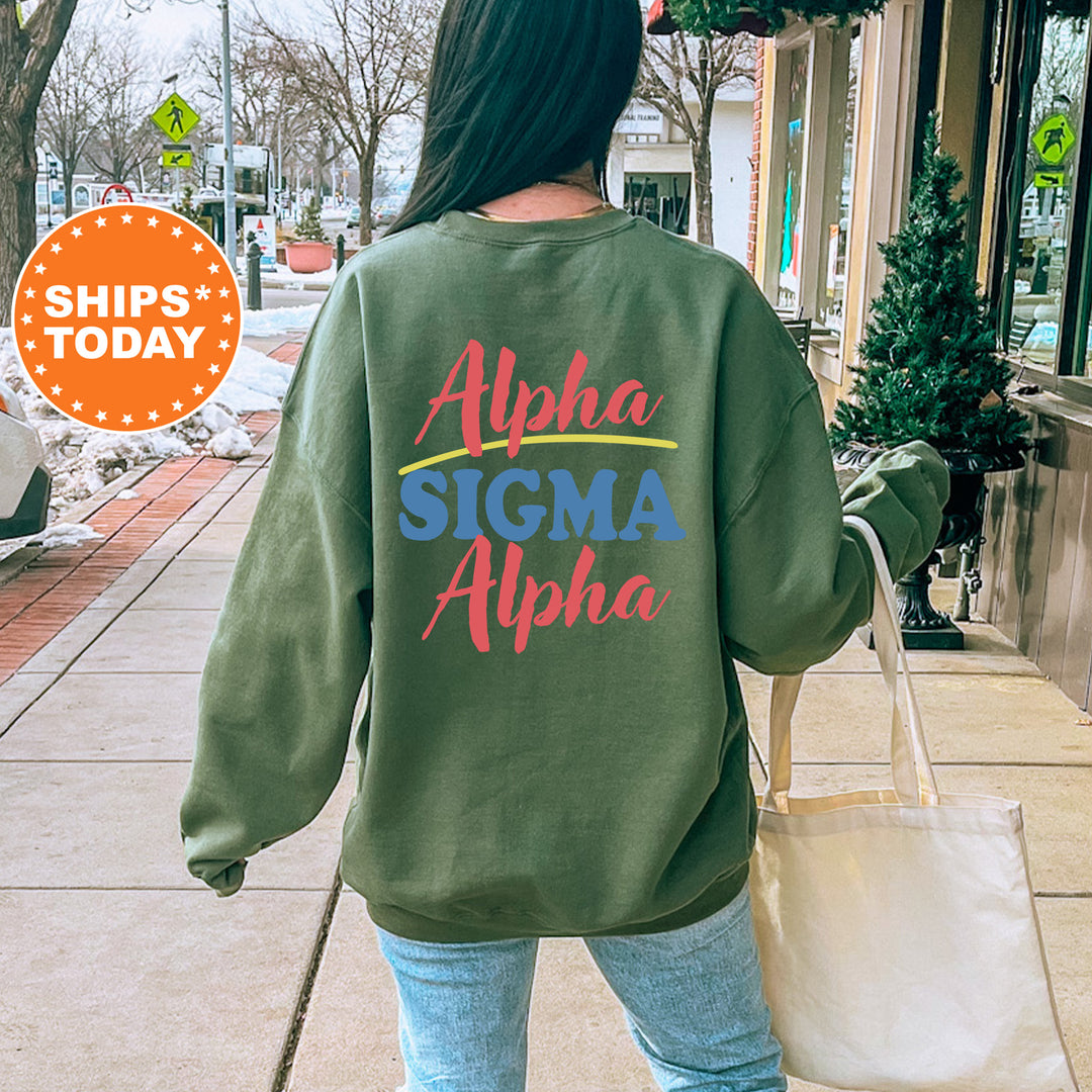 A person wearing a green sweatshirt with the text "Alpha Sigma Alpha" printed on it, walking on a sidewalk.
