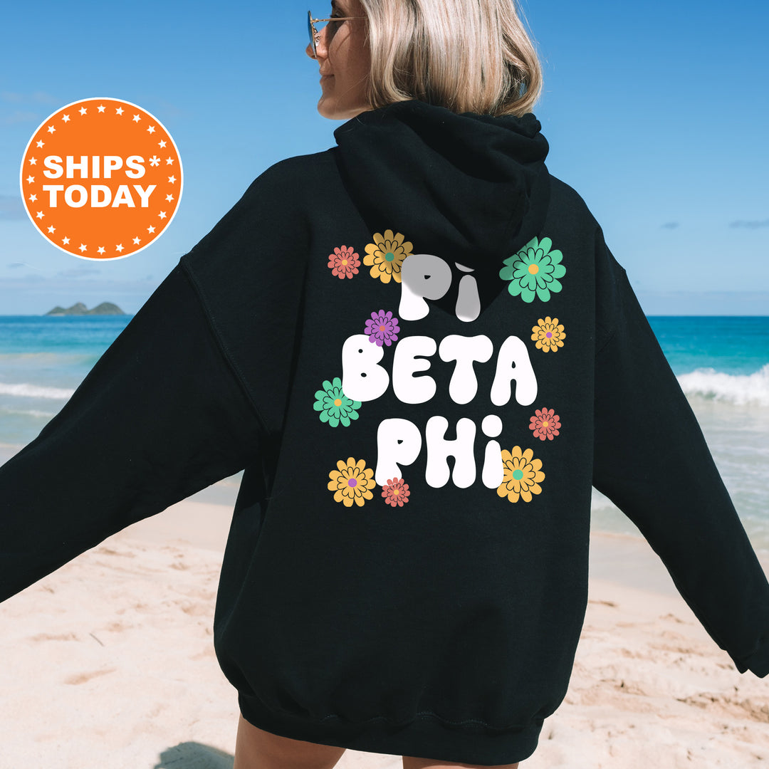 a woman wearing a black hoodie with the words beta phi printed on it