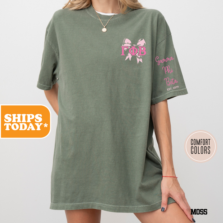 a woman wearing a green shirt with a pink bow on it
