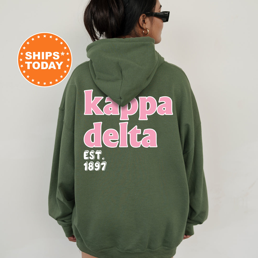 A person wearing a green hoodie with the text " Kappa Delta EST. 1897" printed on the back.