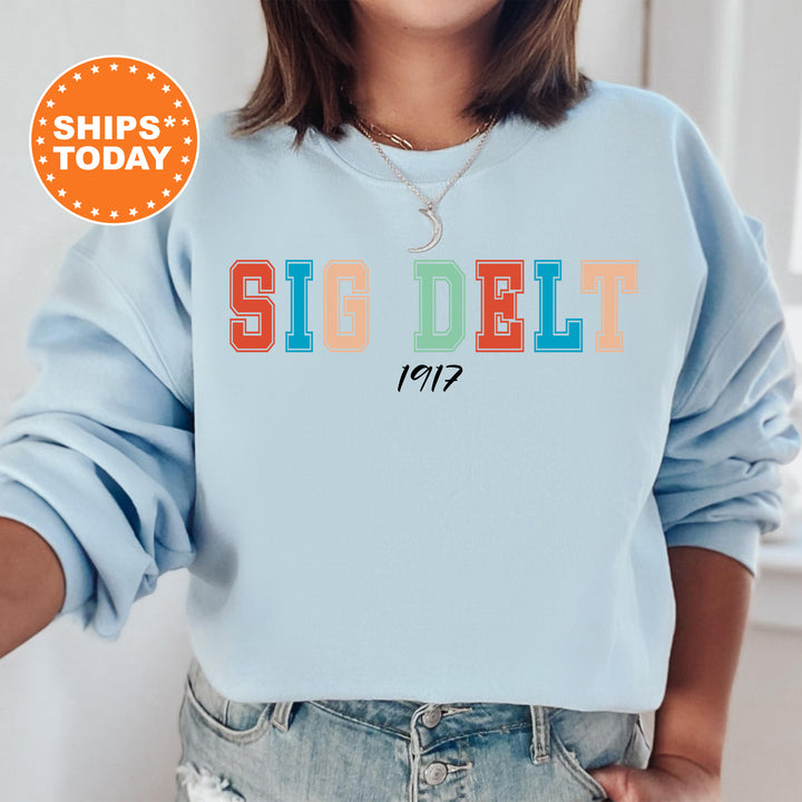 a woman wearing a blue sweatshirt with the word siddelt printed on it