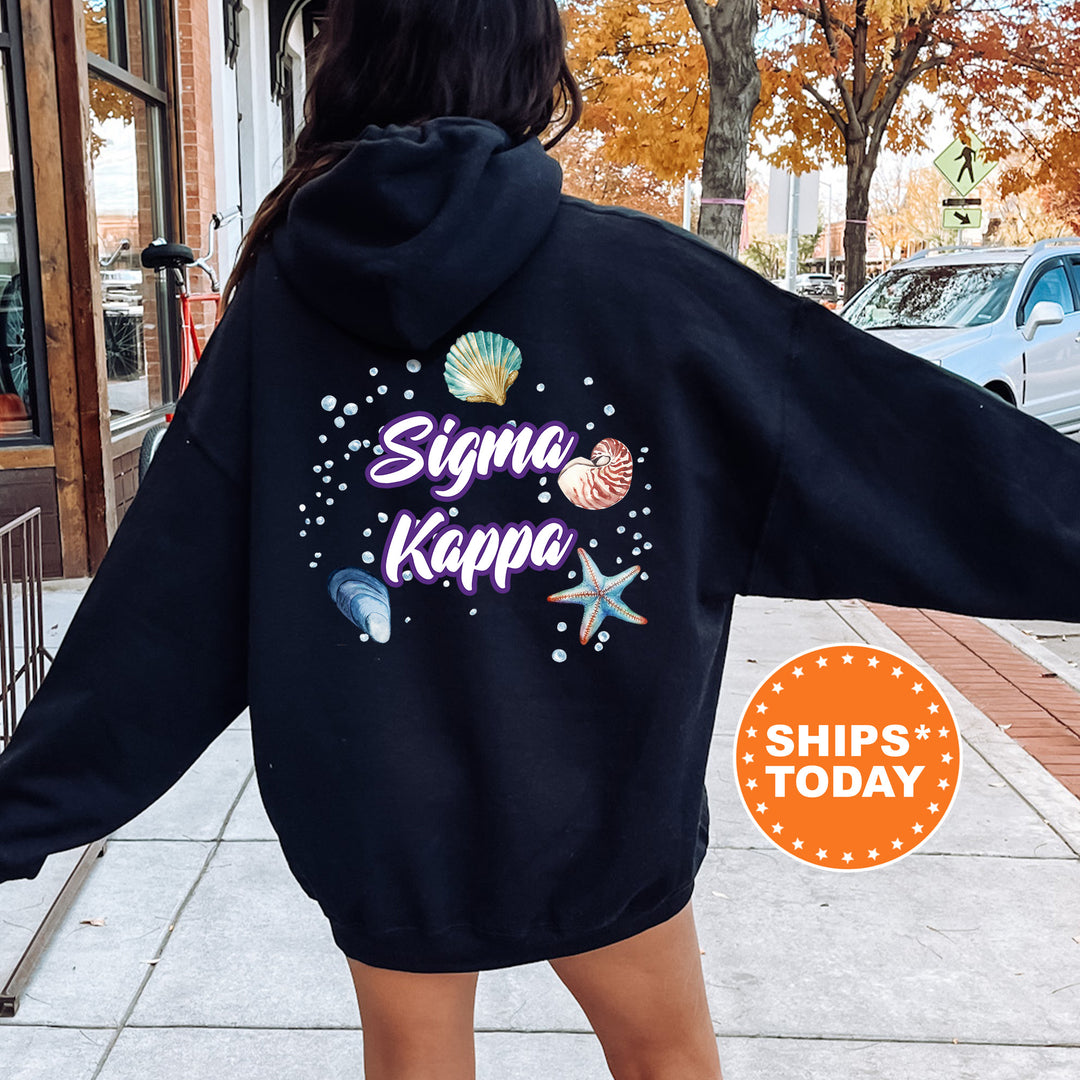 a woman in a black hoodie is walking down the street