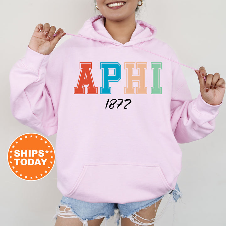 a woman wearing a pink hoodie with the word aphi on it