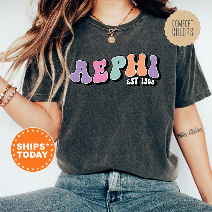 a woman wearing a black shirt with colorful letters on it
