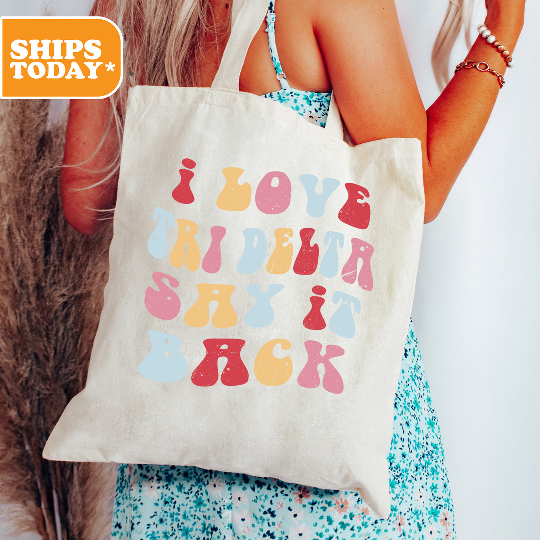 a woman holding a tote bag that says love birds rock