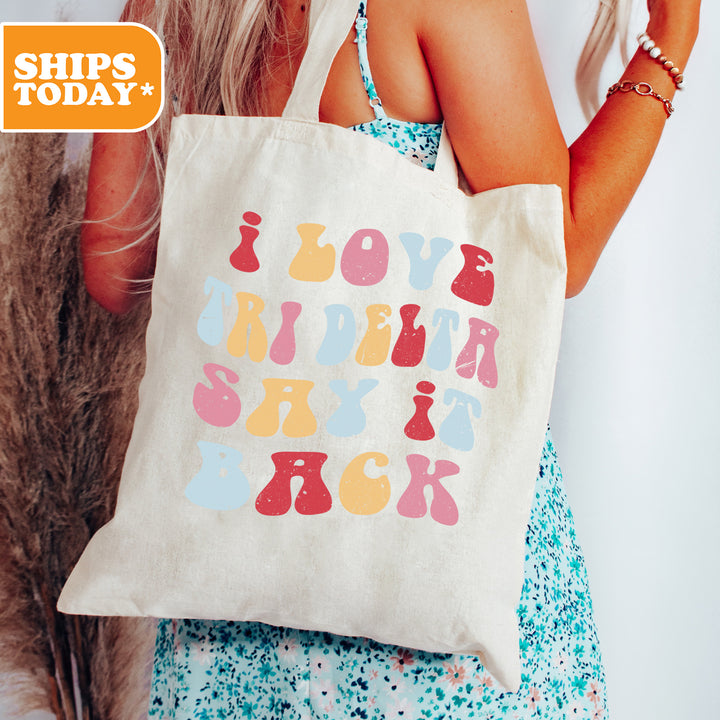a woman holding a tote bag that says love birds rock