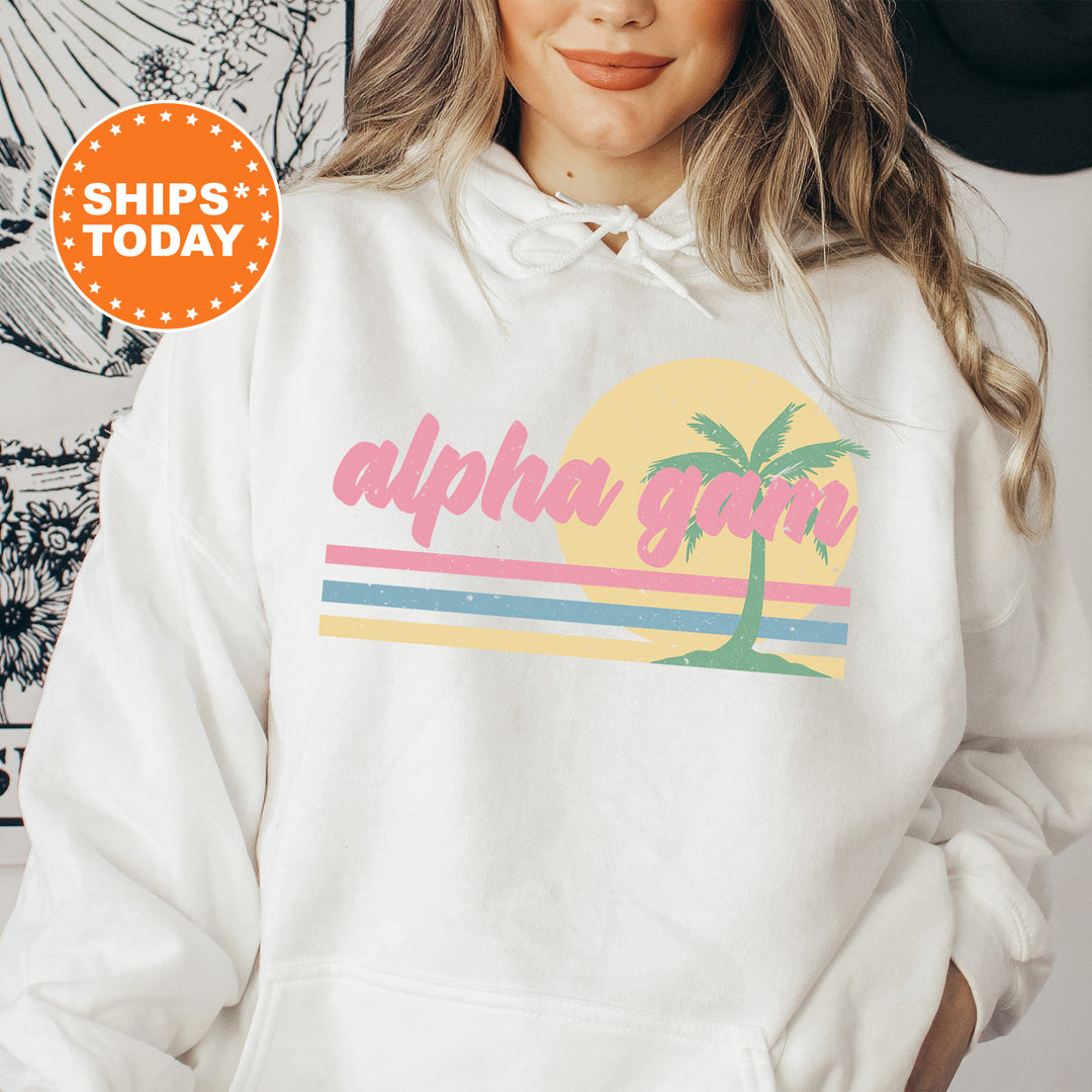 a woman wearing a white hoodie with a palm tree on it