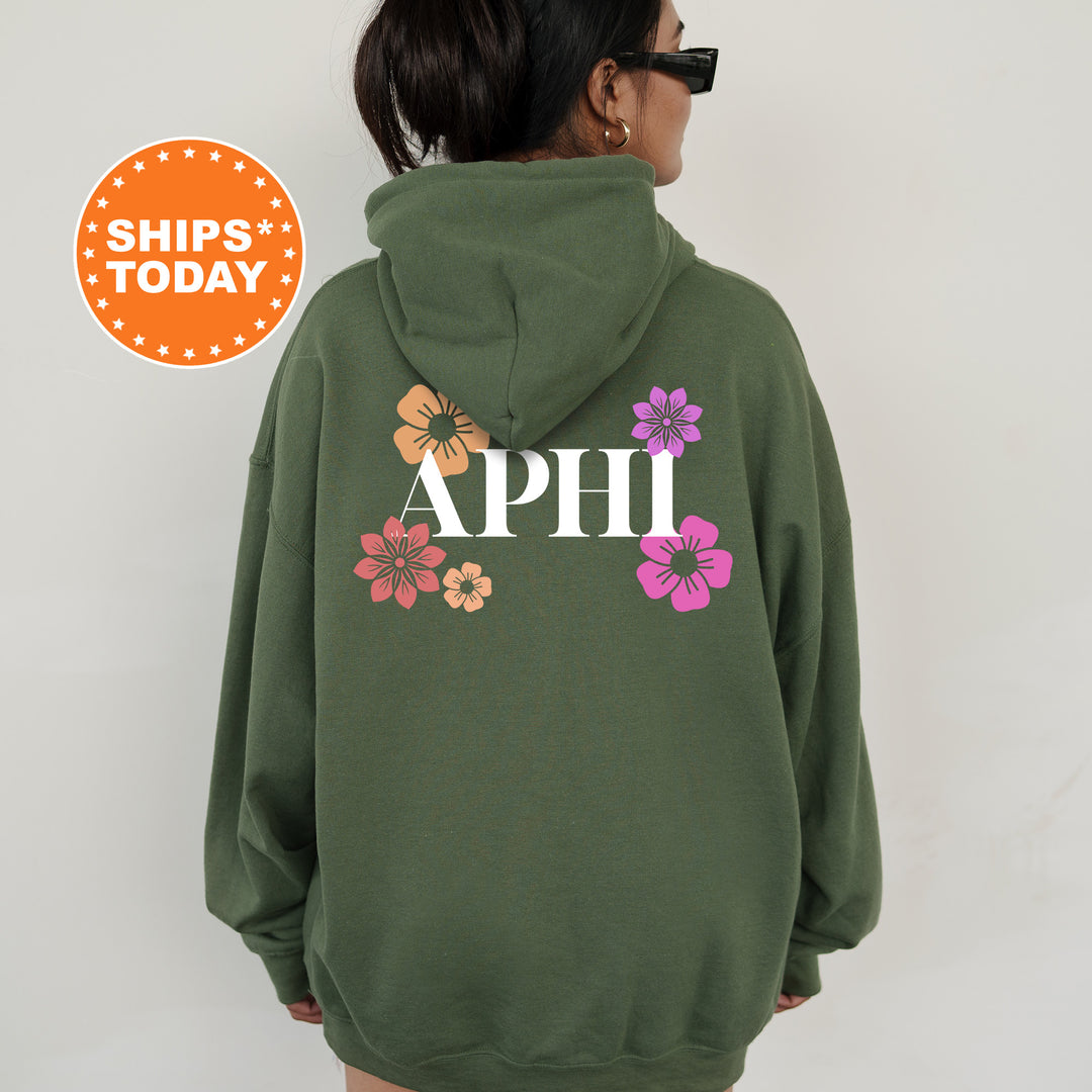 a woman wearing a green hoodie with flowers on it