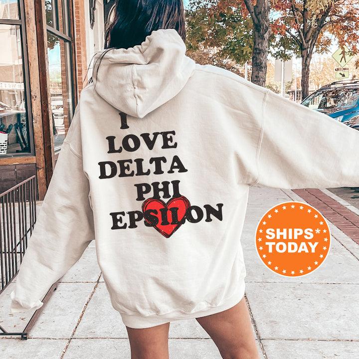 a woman in a white hoodie that says i love delta phi epson