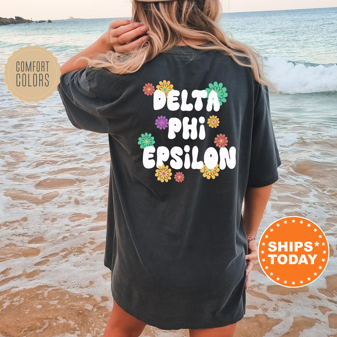 a woman wearing a black shirt that says delta phi epsilon