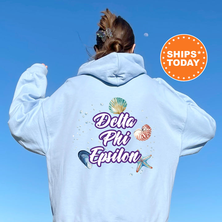 a woman with her back to the camera wearing a white hoodie