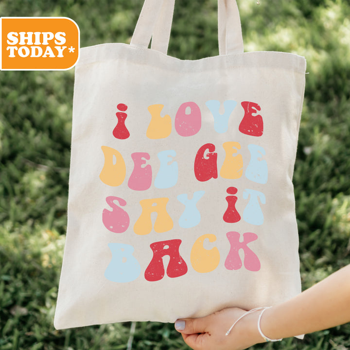 a person holding a tote bag with the words love, joy, and bowling