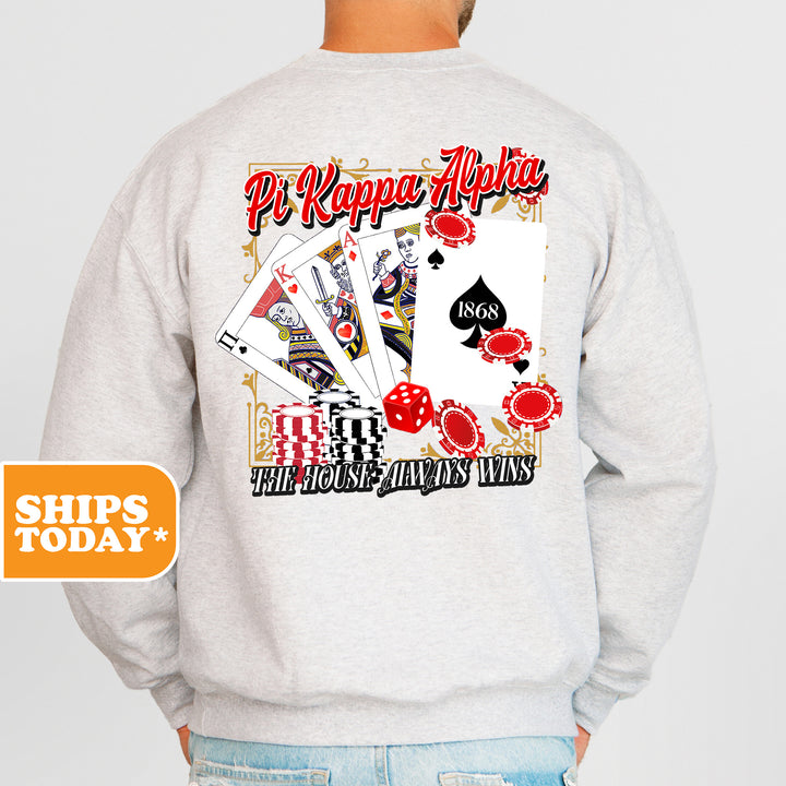 a man wearing a sweatshirt with a picture of playing cards on it