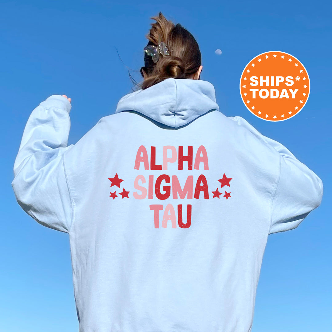 a woman wearing a white hoodie with the words alpha sigma tau