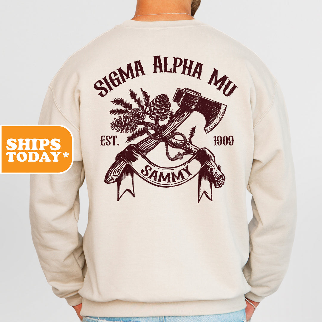 a man wearing a sweatshirt with an image of a hammer and pine cones on it