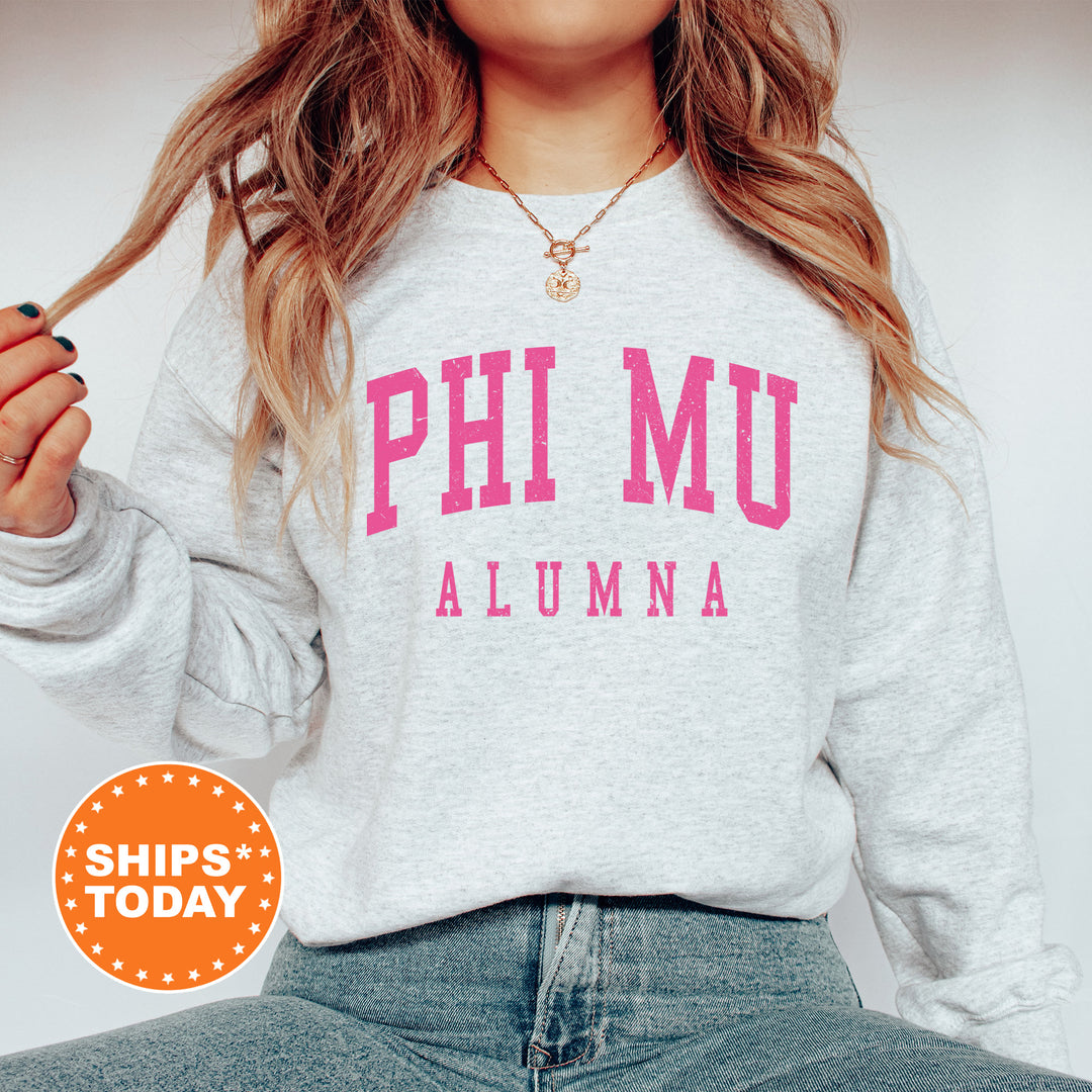 a woman wearing a sweatshirt that says phi mu aluma
