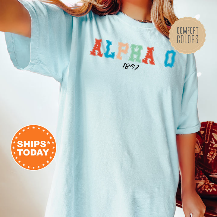 a woman wearing a blue shirt with the word alpha on it