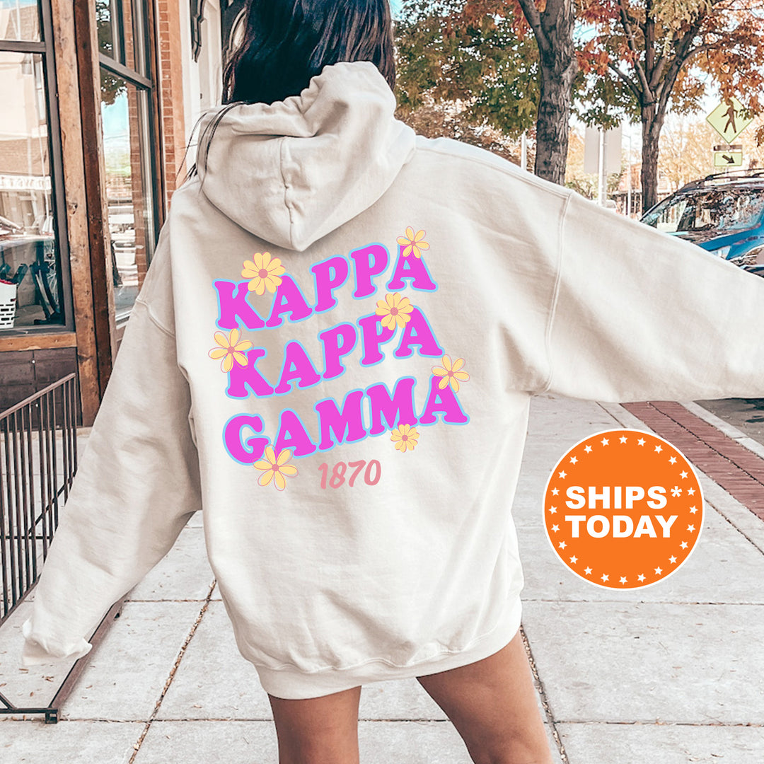 A person wearing a white hoodie with the text "KAPPAK Kappa Gamma" printed on it, standing on a sidewalk.