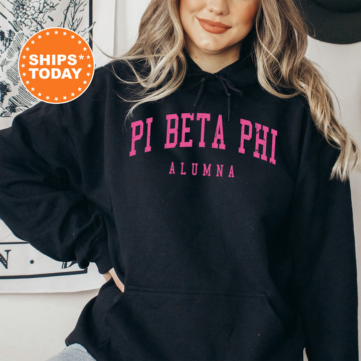 a woman wearing a black hoodie with pink letters