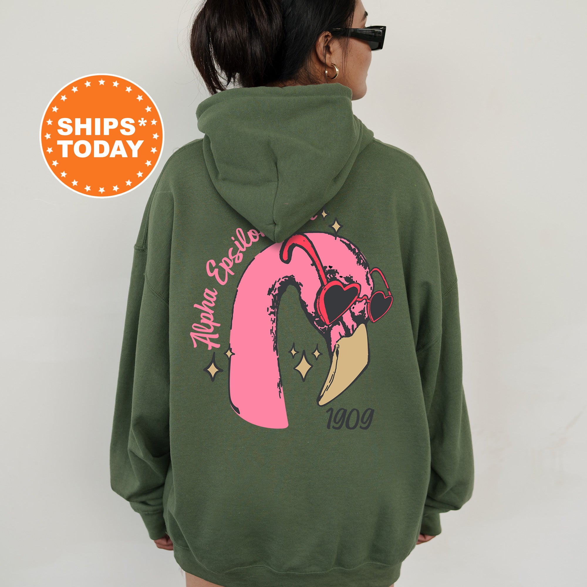 a woman wearing a green hoodie with a pink pony on it