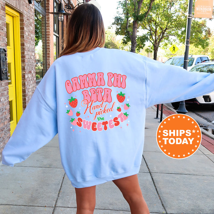 a woman walking down a sidewalk wearing a blue sweatshirt