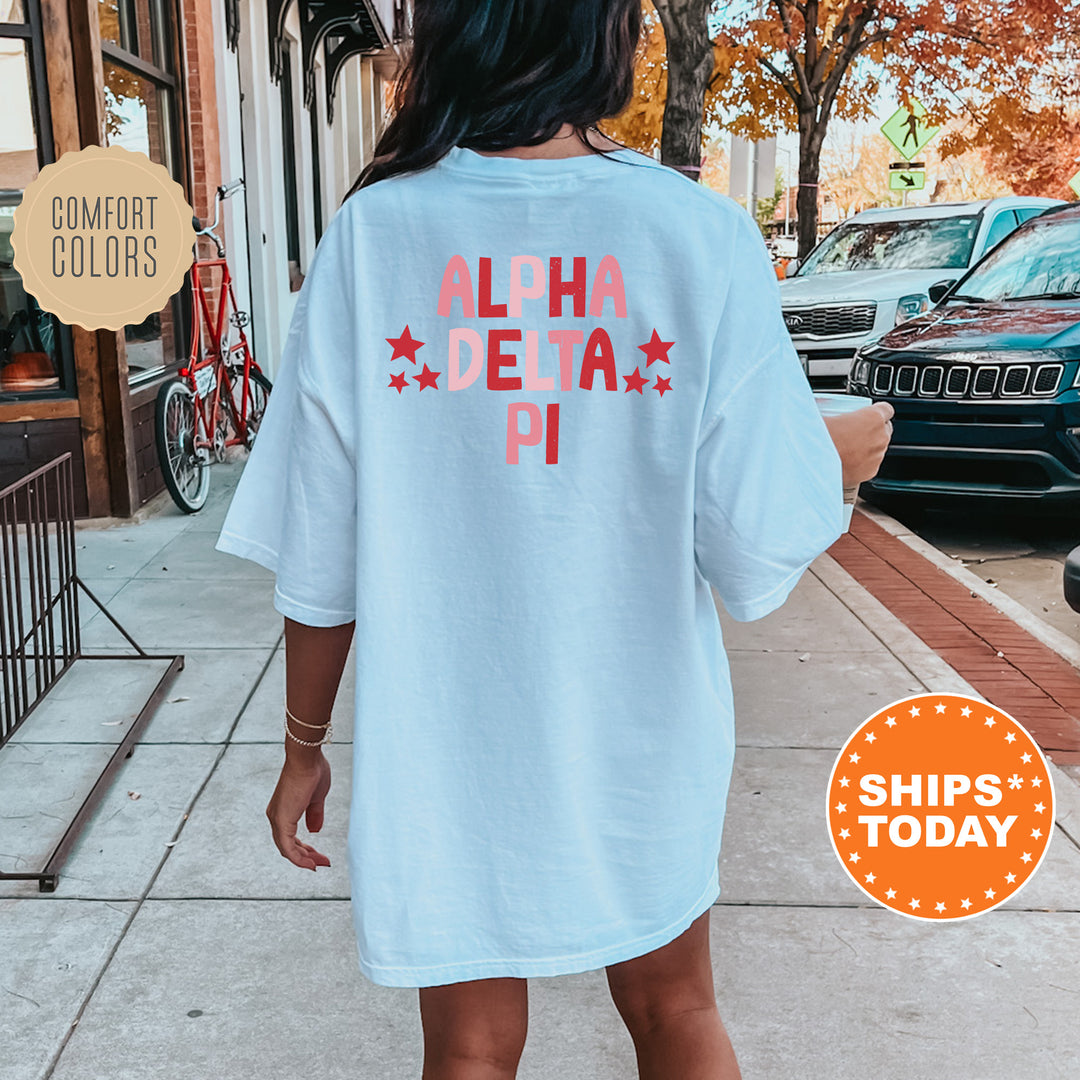 a woman walking down a sidewalk wearing a shirt that says aloha delta pi