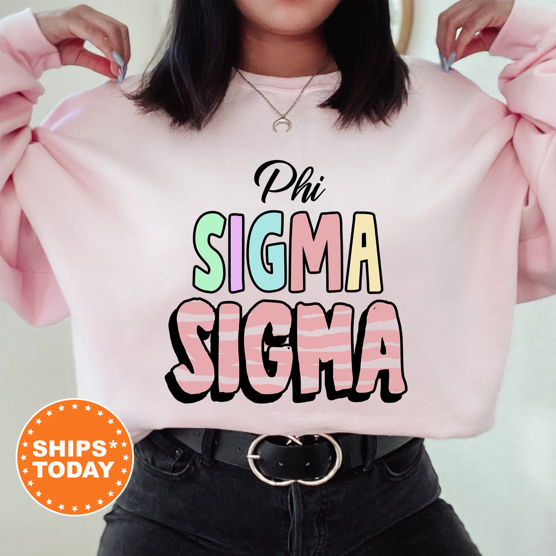 a woman wearing a pink sweatshirt with the words phi sigma sigma