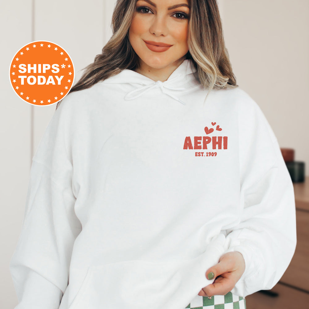 a woman wearing a white hoodie with the words aephii on it