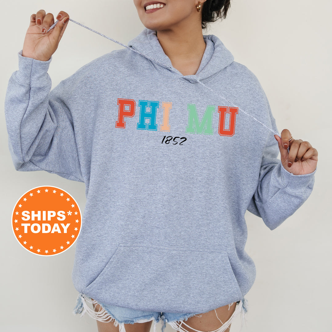 a woman wearing a blue hoodie with the word phumu printed on it