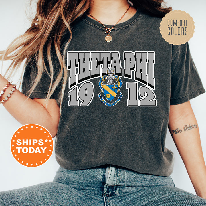 a woman wearing a black shirt with a blue and yellow crest on it