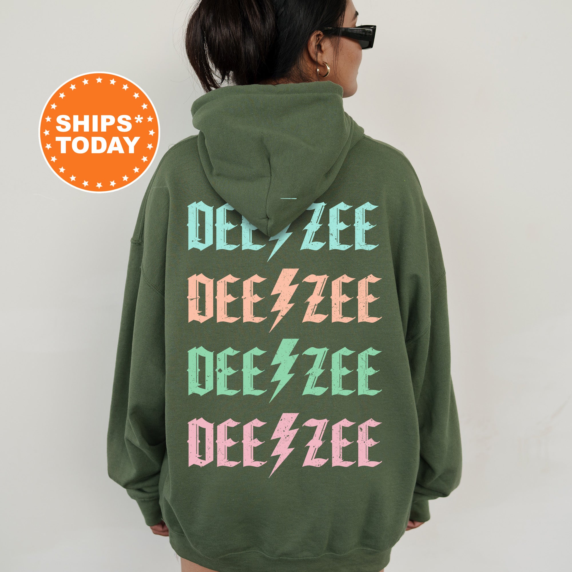 a woman wearing a green hoodie with pink and green letters on it