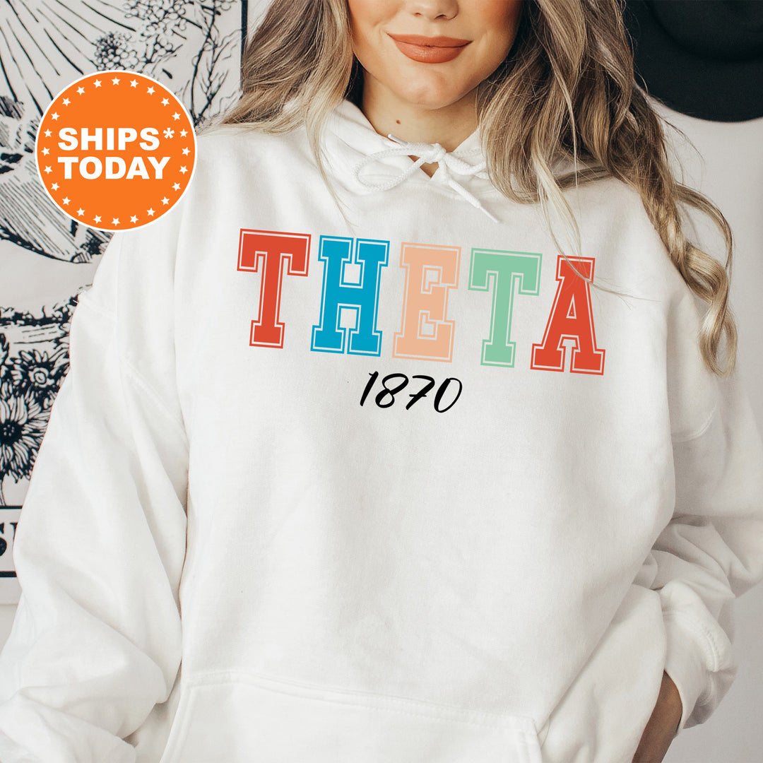 a woman wearing a white hoodie with the word theatre printed on it