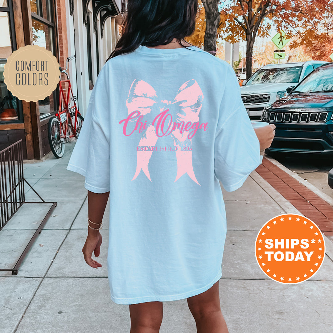 a woman is walking down the sidewalk with a pink bow on her shirt