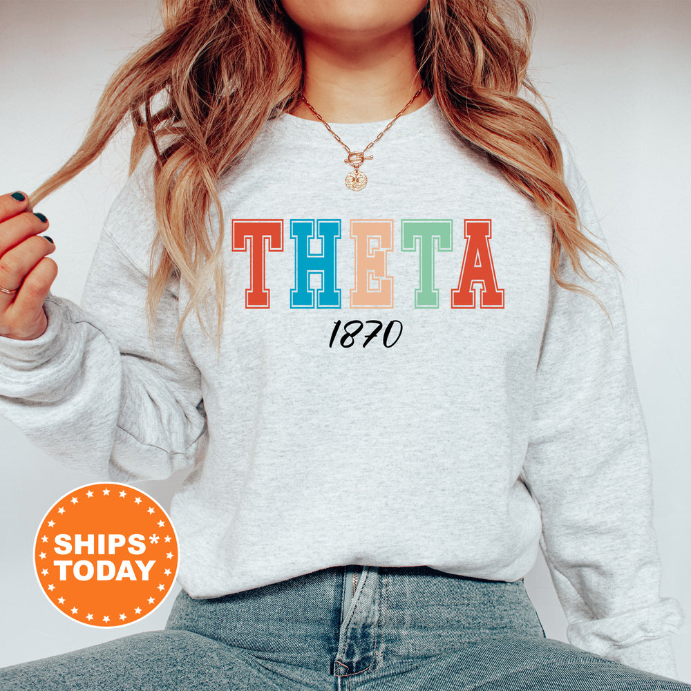 a woman wearing a sweatshirt with the word thea printed on it