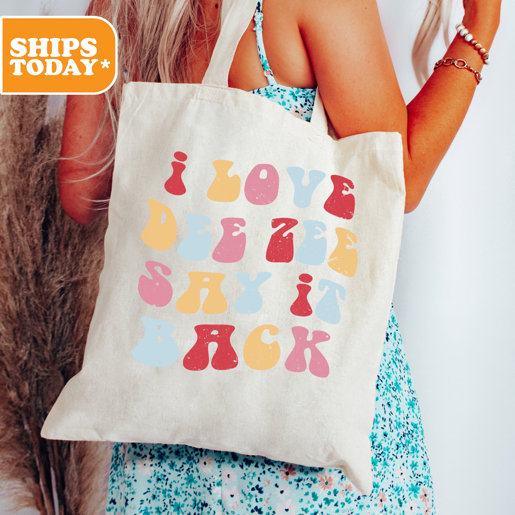 a woman holding a tote bag with a message on it