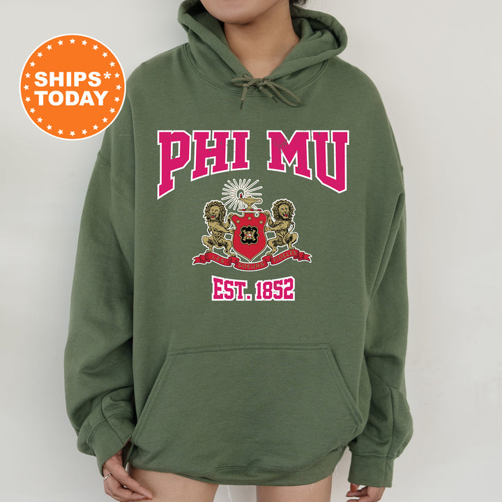 a person wearing a green hoodie with the phi mu logo on it