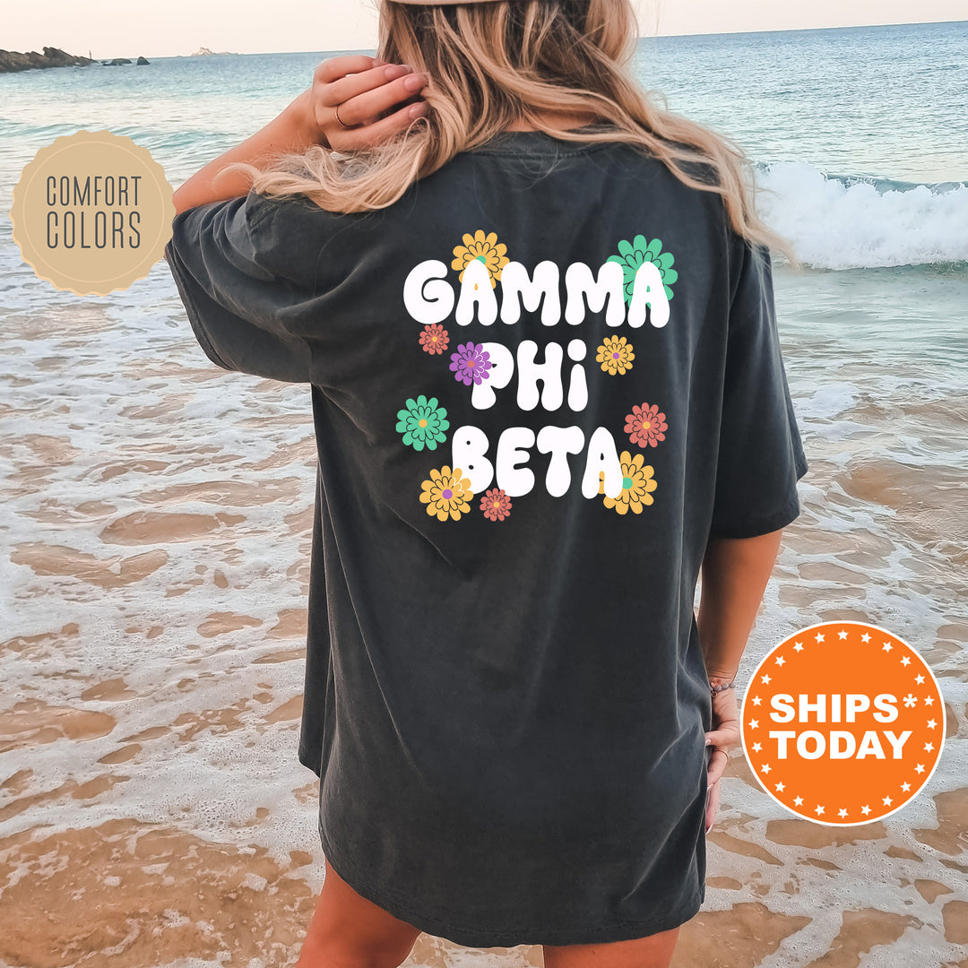 a woman standing on a beach wearing a black shirt