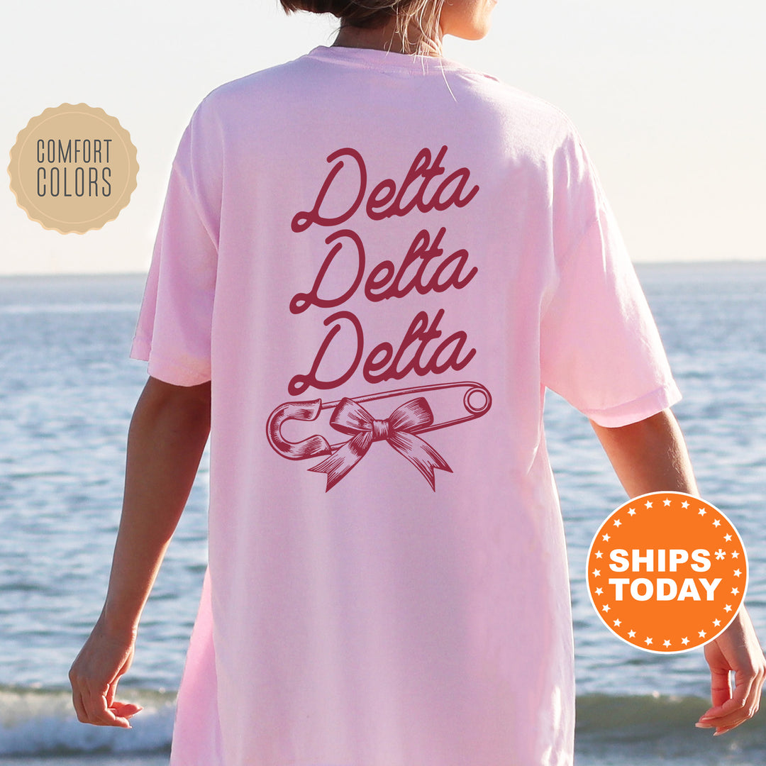 a woman wearing a pink shirt that says delta delta delta